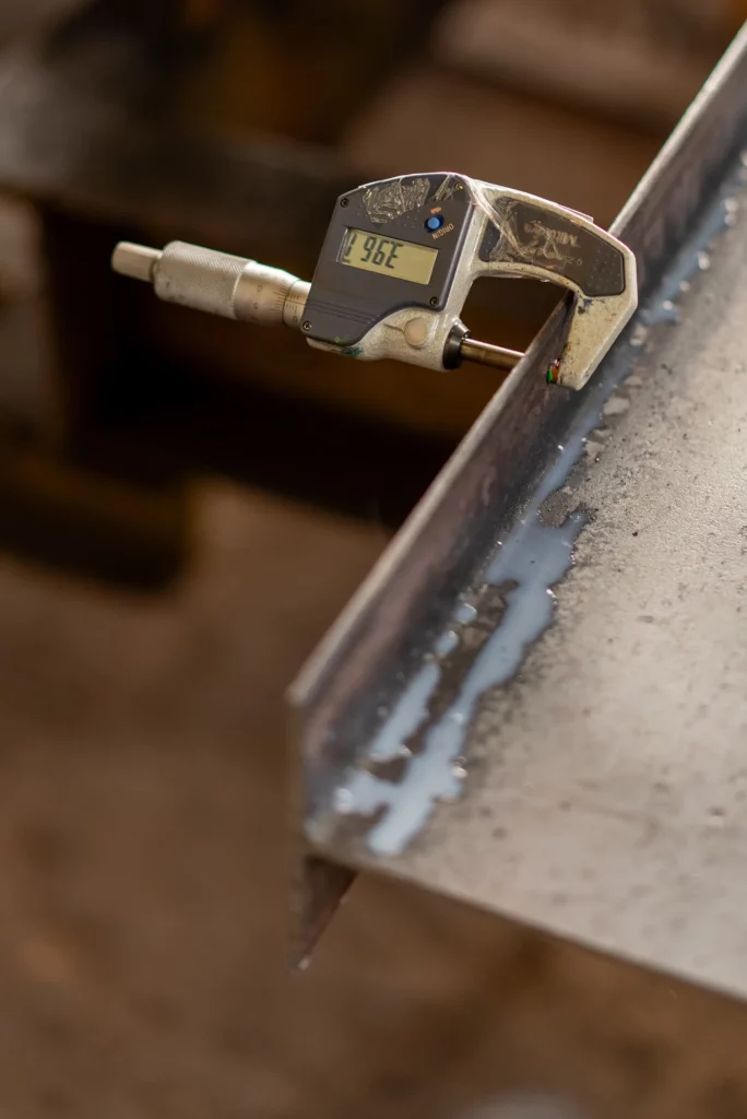 Digital micrometer checking metal sheet thickness for chemical etching